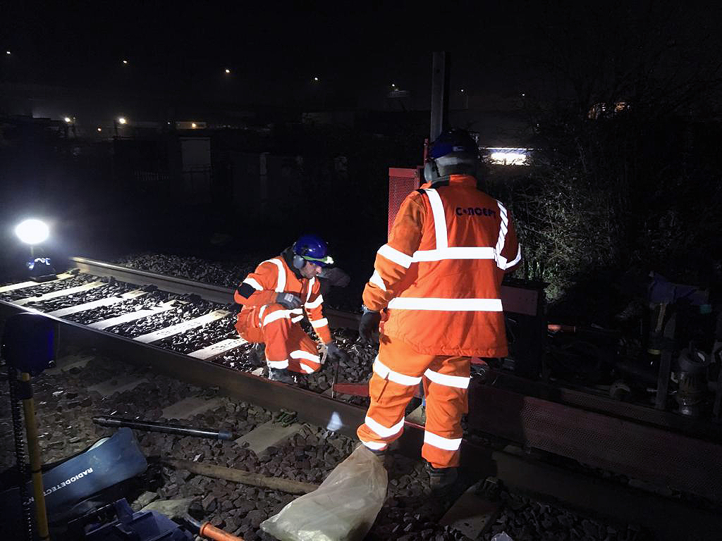 Two site operatives during a night shift of work on a train track 