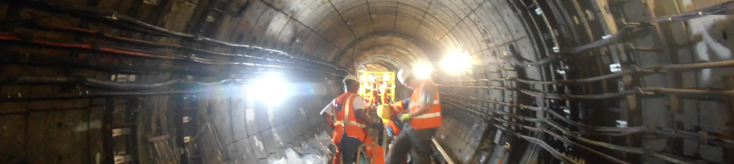 3 site operatives carrying out investigations inside a tunnel